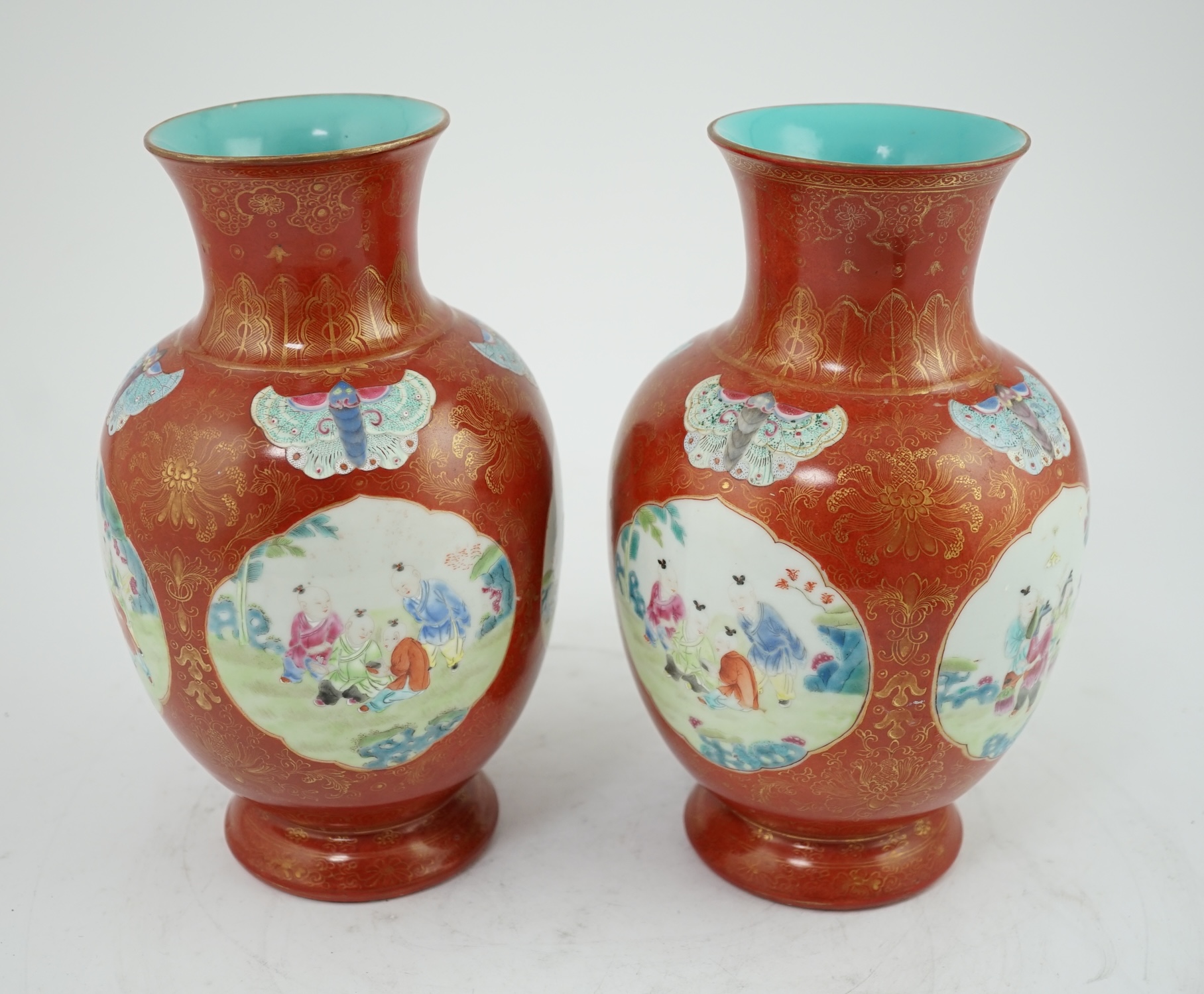 A pair of Chinese coral ground ‘boys’ vases, Jiaqing period (1796-1820)